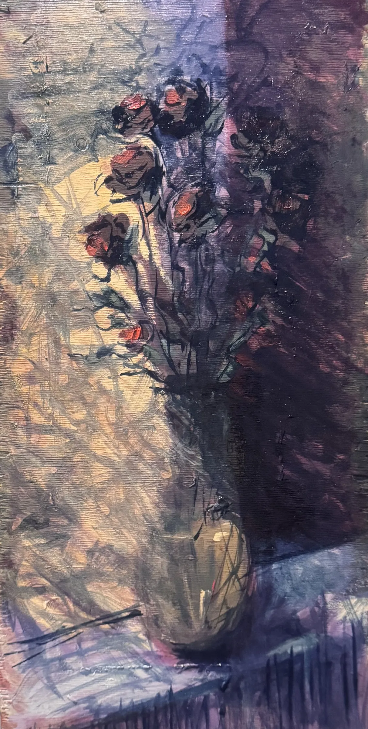 Dark roses in a pale vase against violet shadow