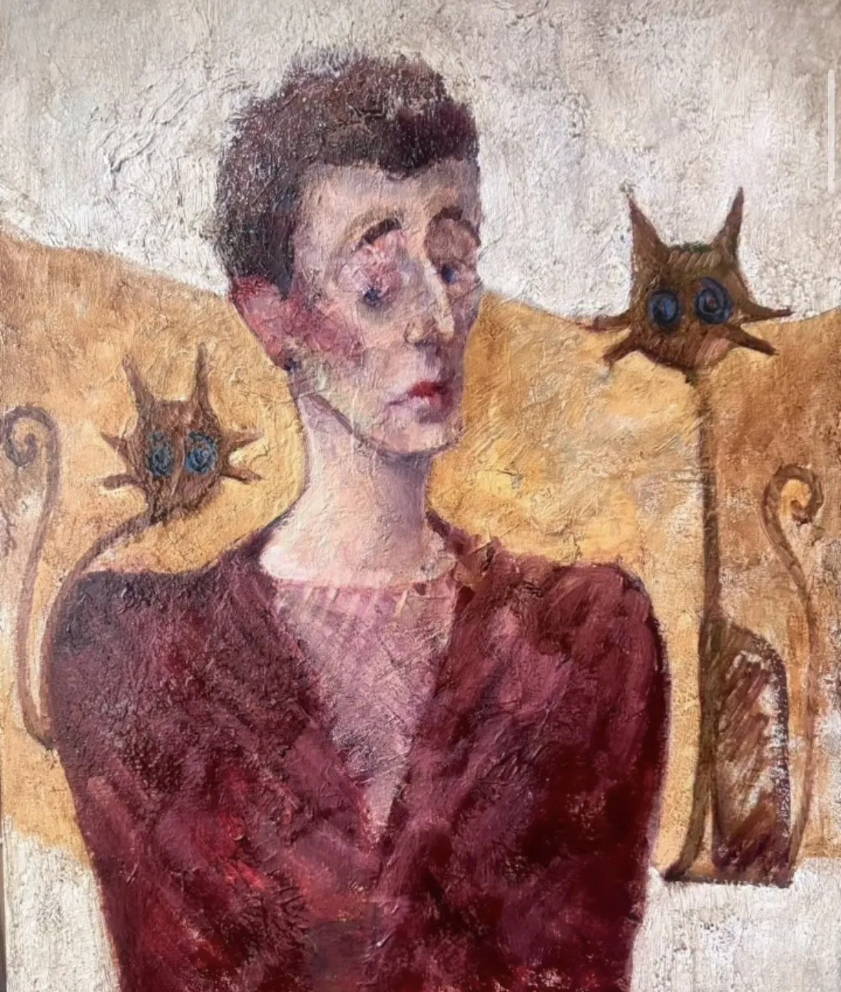 Woman in a crimson dress between two cats on an ochre ground