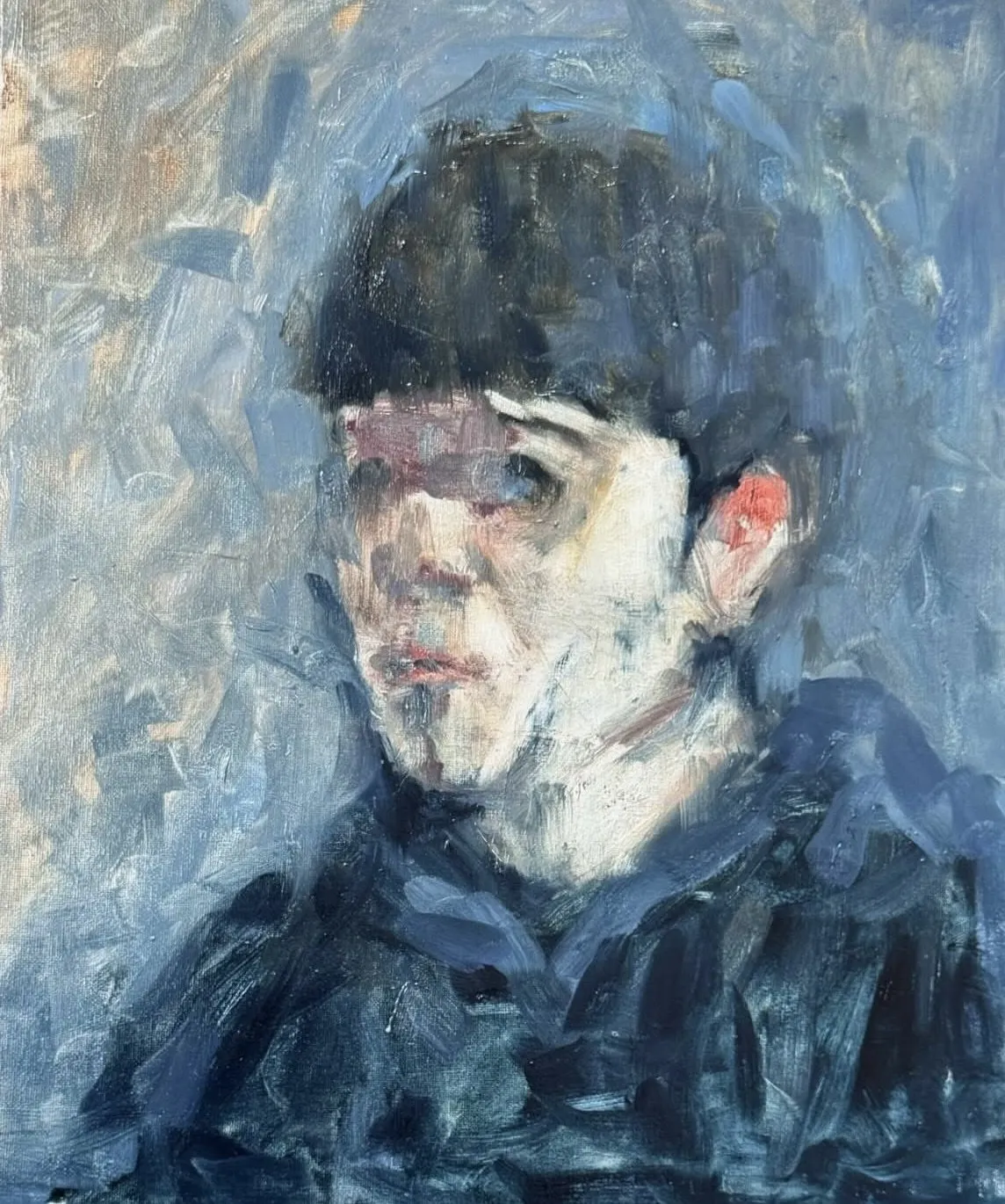 Boy in blue, hair falling across the eyes