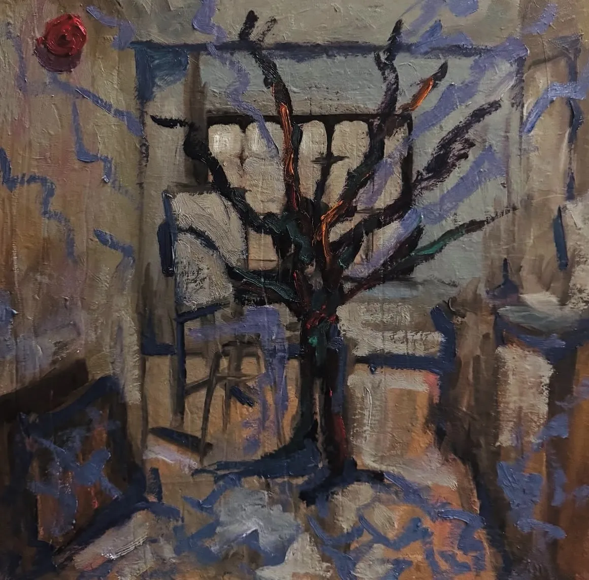 Bare tree among blue and ochre buildings